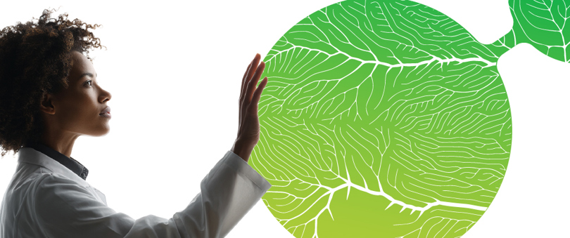 Teva scientist interacting with a large green abstract network graphic illustrating biological pathways and potential pathways for business growth.