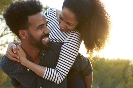 A couple with ADHD share a moment of laughter during a date outdoors.